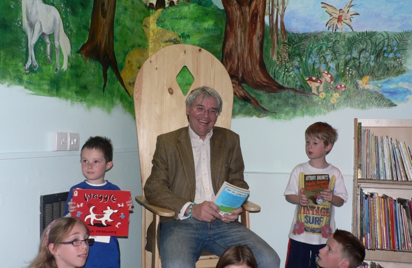 Andrew reading the children a story at Holy Cross School